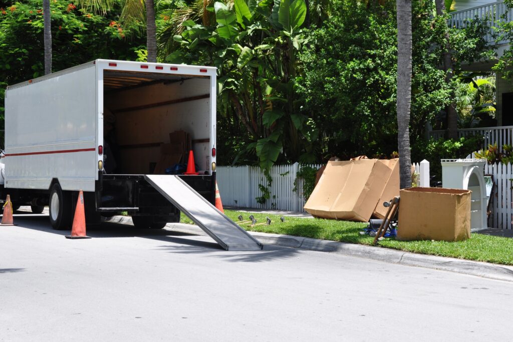 A,Moving,Van,On,Street,With,Ramp,,Boxes,And,Household